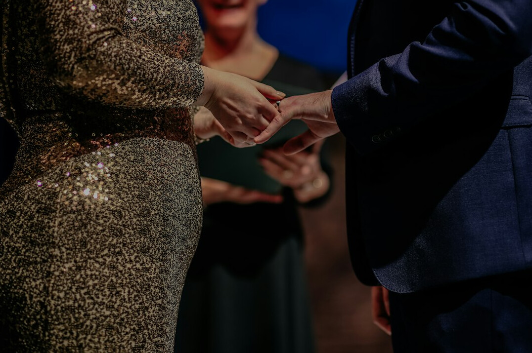 Two people shaking hands over a desk with documents