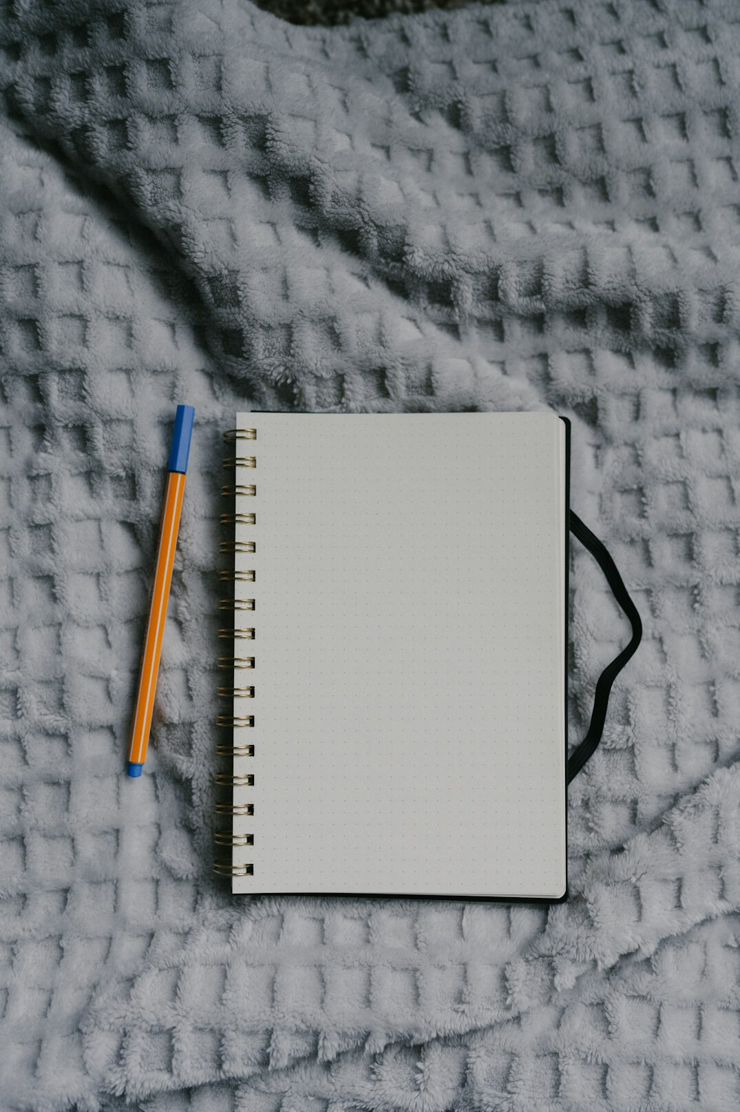 Open notebook with handwritten verification checklist and pen
